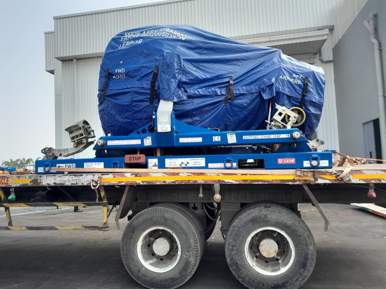 Flatbed transporting a jet engine module