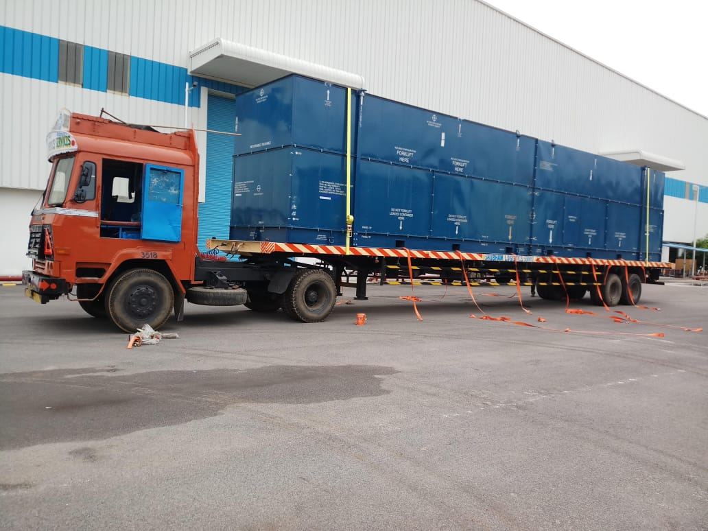 Multi-vehicle convoy carrying crated equipment