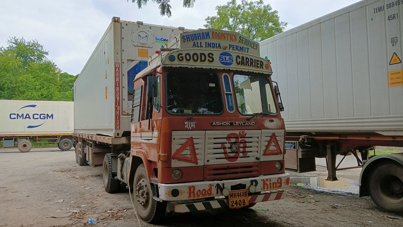SLS vehicle alongside a reefer shipping container