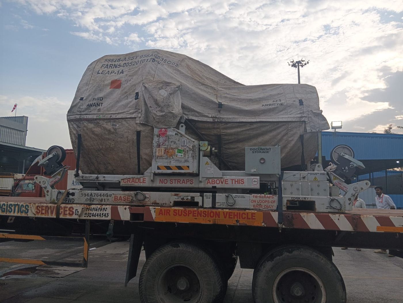 Flatbed transporting a jet engine module